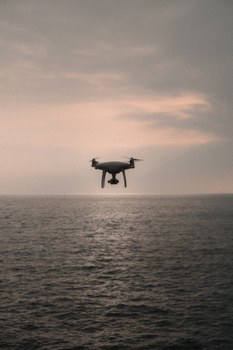 Drone over the ocean during the sunset