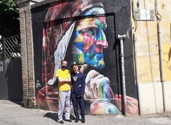 David and a friend standing in front of a mural depicting Dante