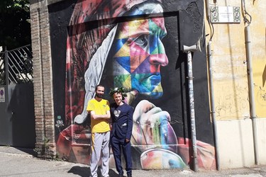David and a friend standing in front of a mural depicting Dante
