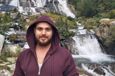 Mohammed in front of a waterfall