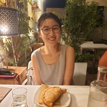Xiaoli smiling right before eating a panzerotto
