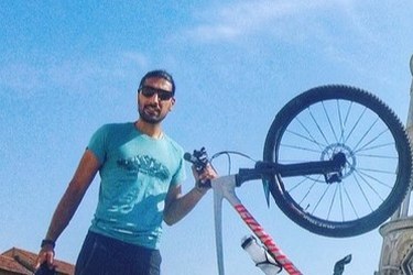 Majid holfding his bike