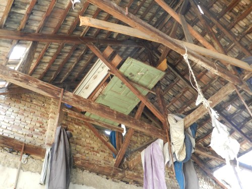 A door balances on beams in rafters